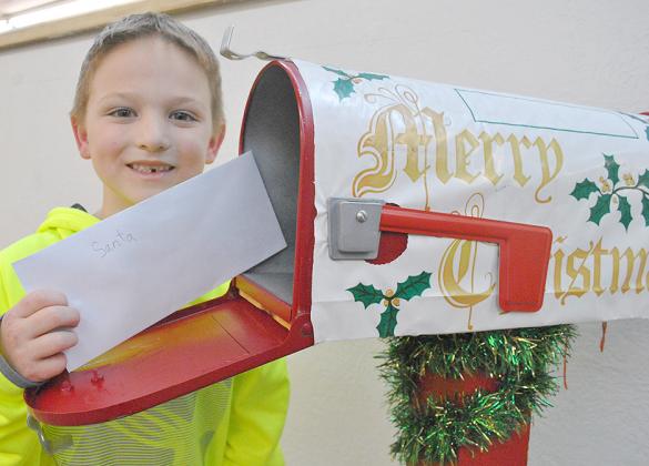 Braxton McClurg placed his letter to Santa Claus in the Snyder Daily News’ North Pole mailbox last week. Children may submit letters to Santa at the newspaper office through Dec. 14.